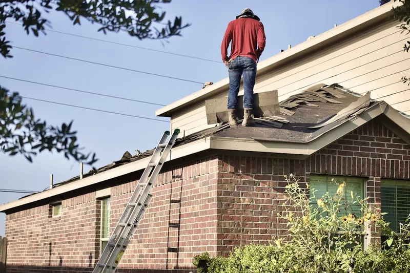 Professional roofer working on a residential roof in Shadow Wood